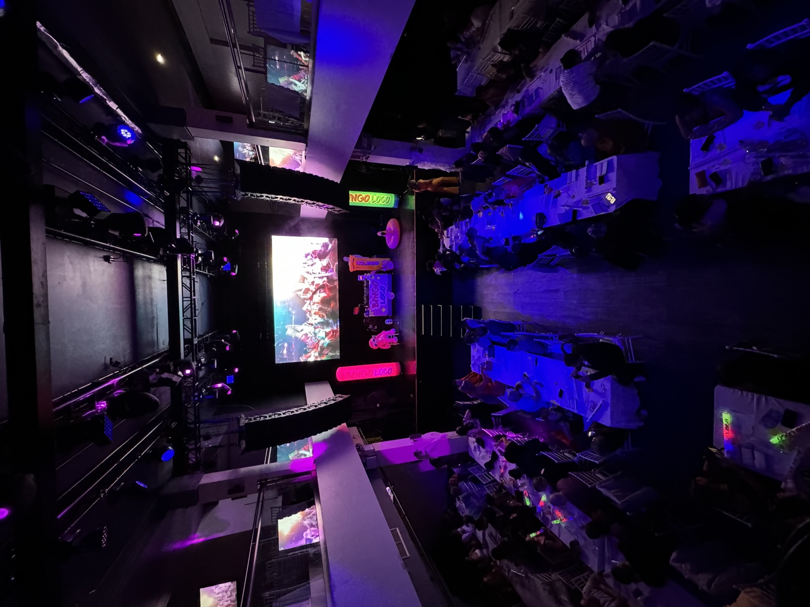 Club venue with LED screen, moving heads on truss and purple wash lighting